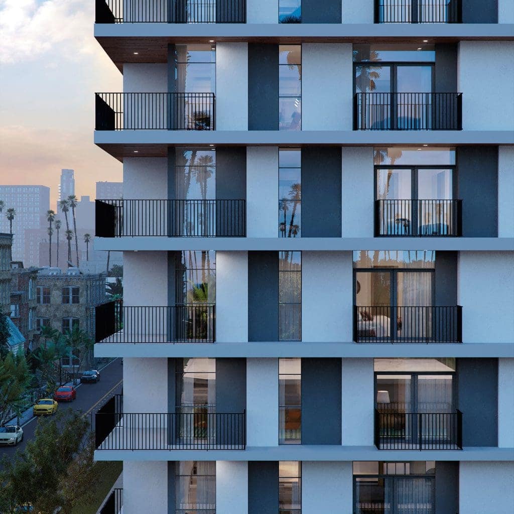 Contemporary residential apartment building with modern balconies and floor-to-ceiling windows.