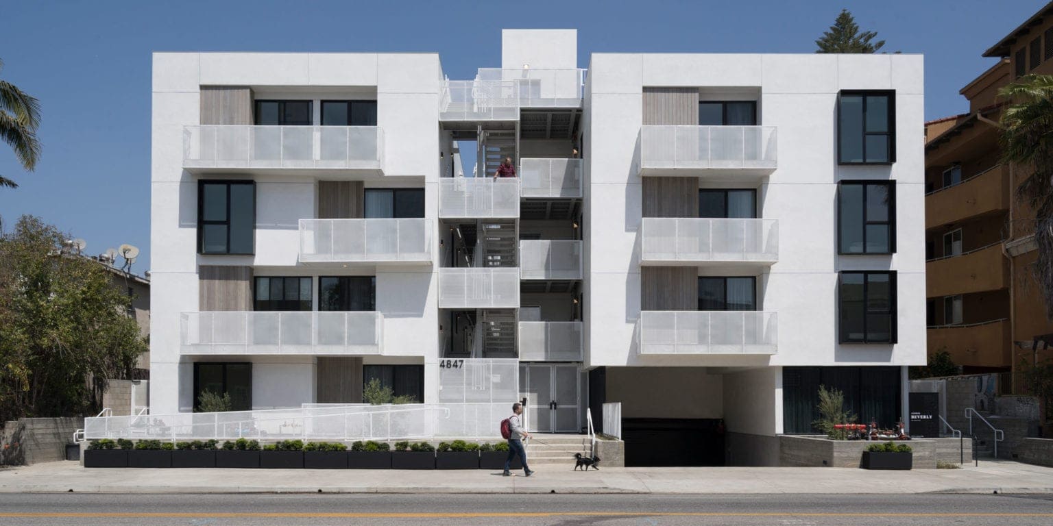 Exterior view of Los Angeles TOC housing in Larchmont designed by Bittoni Architects, showing contemporary massing and balconies facing the street.