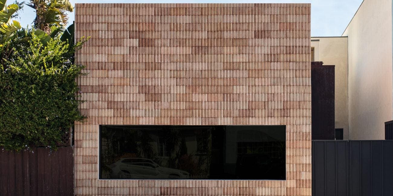 Modern residential exterior with a distinctive brick facade.