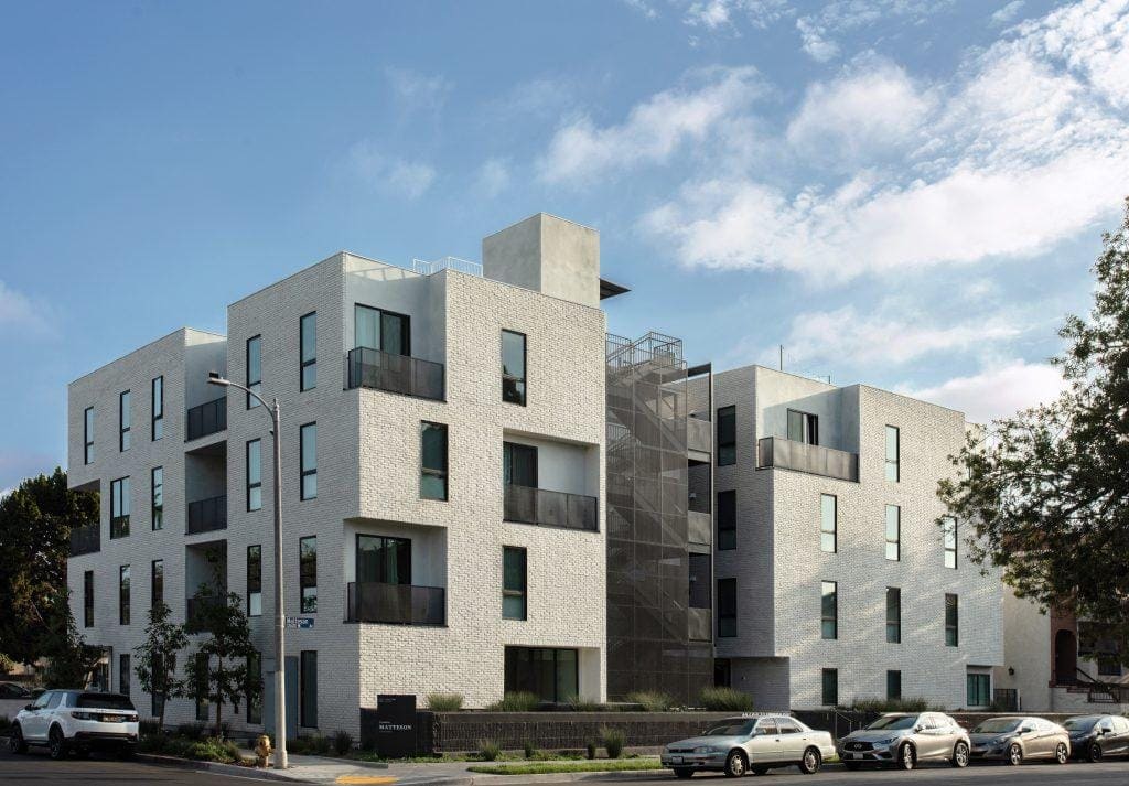 Contemporary residential apartment building with modern brick façade and balconies.