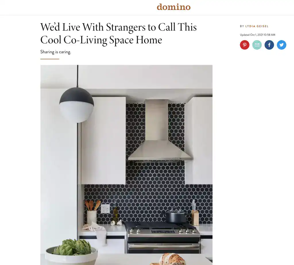 Black and white kitchen with hexagonal tile backsplash and modern appliances.