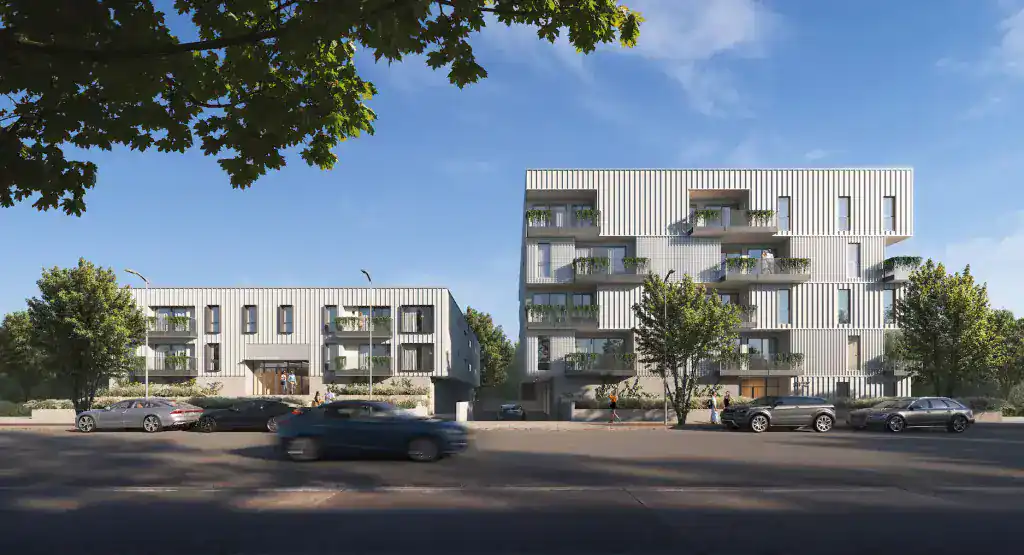 Contemporary residential apartment buildings with modern architectural design and green balconies.