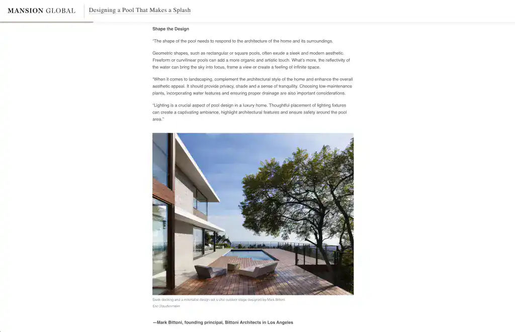 Contemporary modern house with large glass windows, minimalist wooden deck, and a sleek pool area under a blue sky.