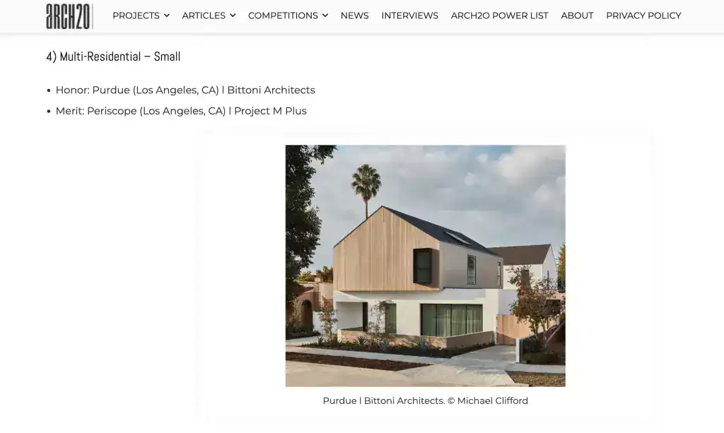 Contemporary two-story residence with a minimalist design, combining natural wood and white stucco materials, featuring angular rooflines and large windows.
