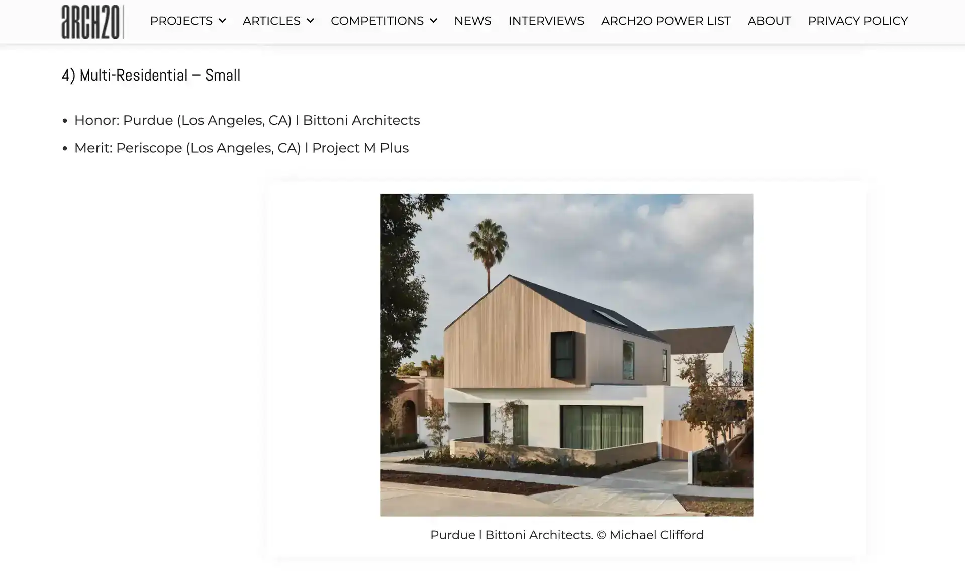 Contemporary two-story residence with a minimalist design, combining natural wood and white stucco materials, featuring angular rooflines and large windows.