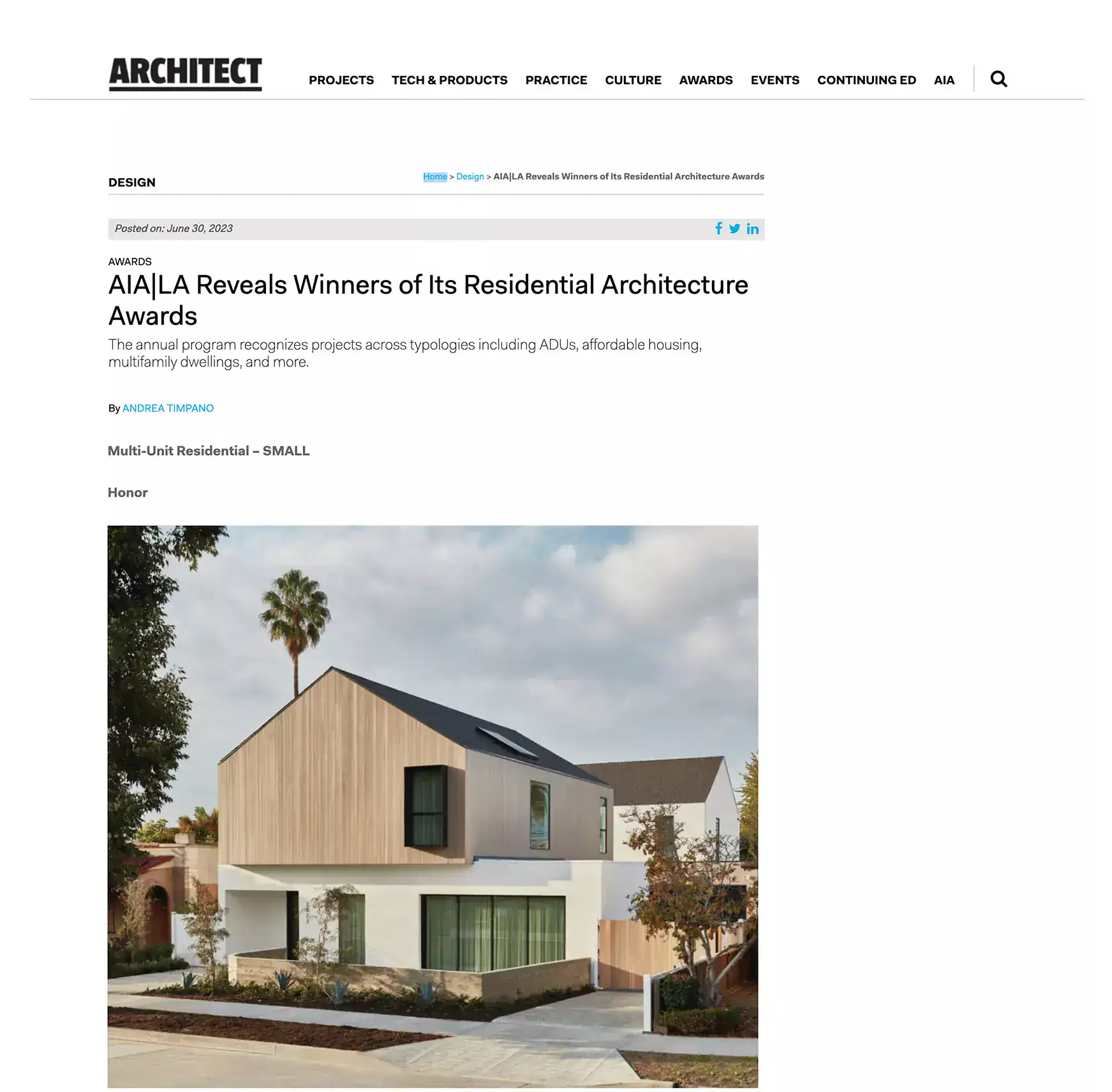 Modern residential house with a mixed material facade, featuring wood and stucco exterior, angular roofline, and large windows, set in a landscaped suburban environment.